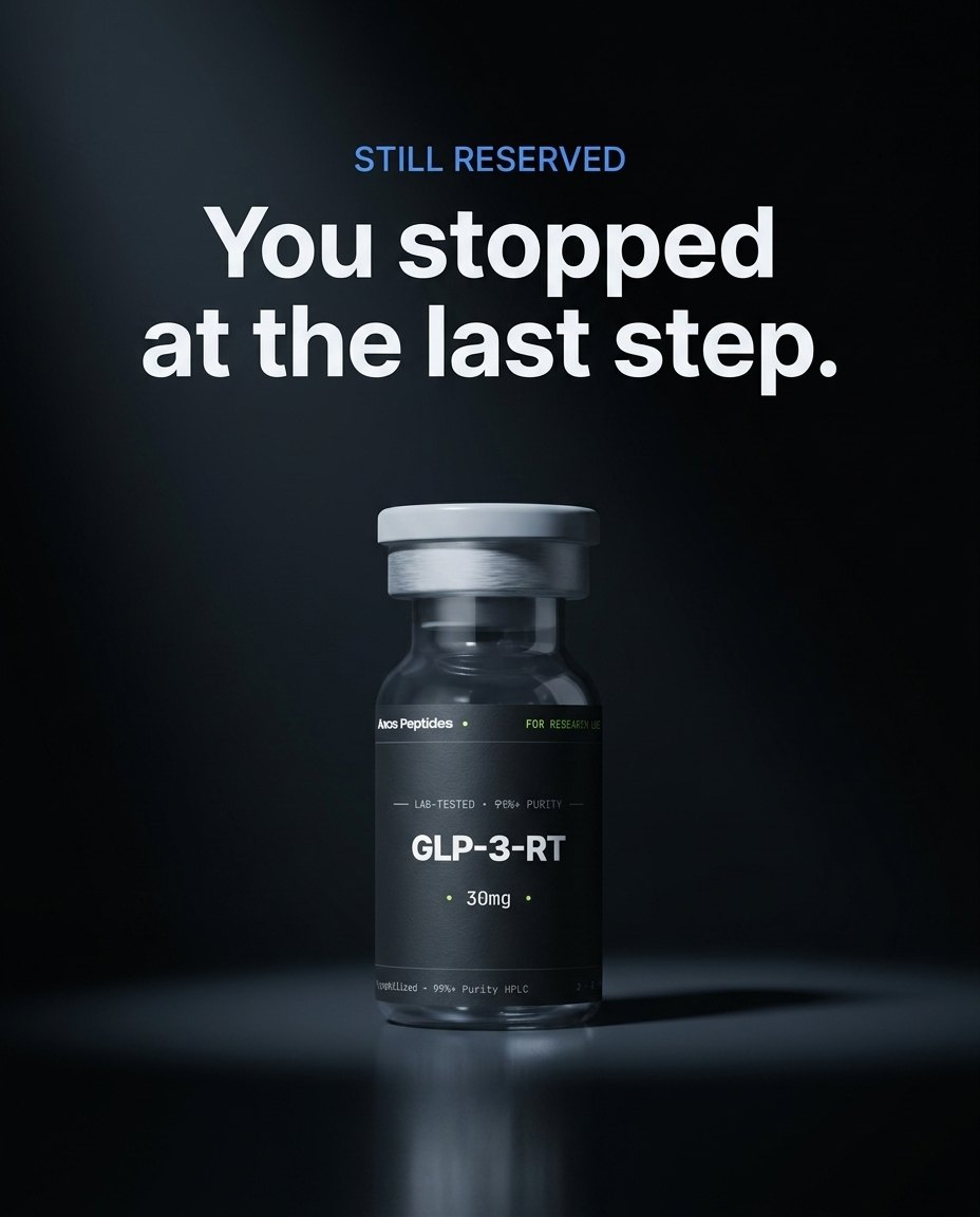 A single Axos vial held in a pool of light against graphite — still reserved.